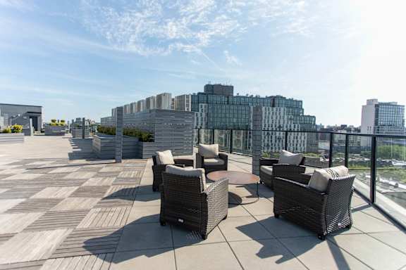 Rooftop terrace with lounge seating and city views at 1134 Fulton Street Apartments, Brooklyn, 11216