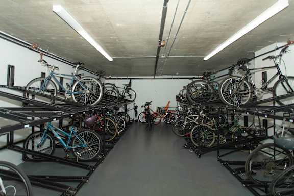 Indoor bicycle storage room with two tier racks at 1134 Fulton Street Apartments, Brooklyn