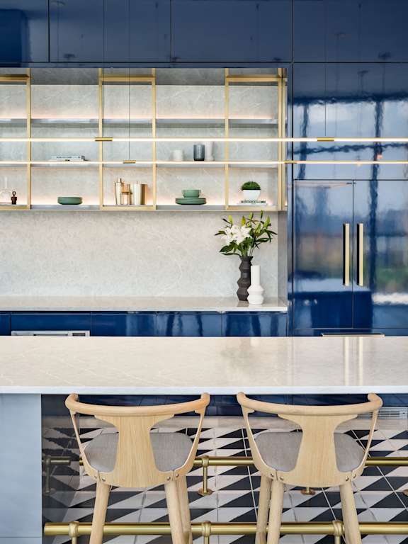 a kitchen with blue and white tiles and a table and chairs at The Lively, New Jersey