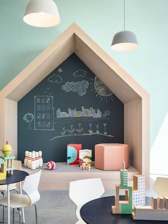 a childs playroom with a chalkboard wall in the shape of a house at The Lively, Jersey City, 07302