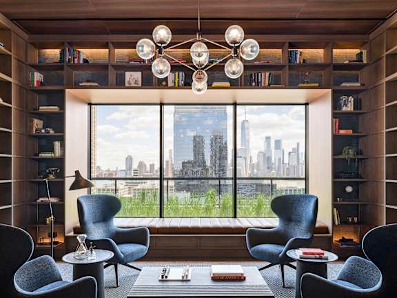 a living room with a large window and chairs and a table at The Lively, Jersey City, NJ 07302
