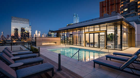 the pool on the rooftop of a building in the city at night at The Lively, New Jersey