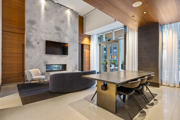 a dining room with a table and chairs and a stone fireplace at The Paxton, New york