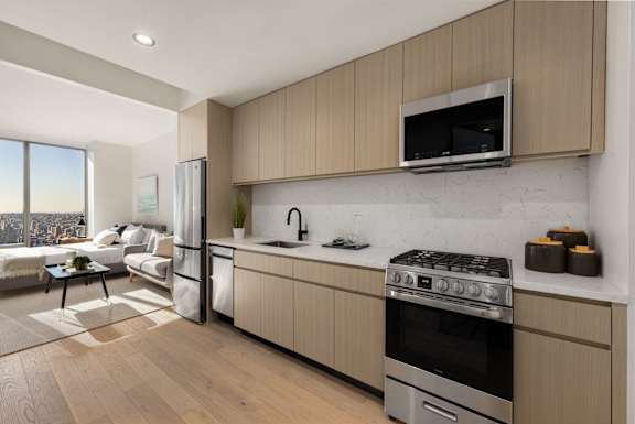 A modern kitchen with a stove top oven and a microwave above the counter.