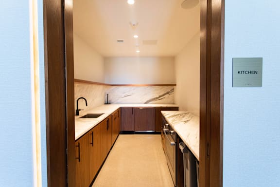 A kitchen with a sign that says "KITCHEN" on the wall.