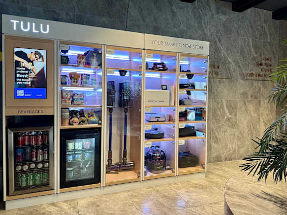 a refrigerated display case in the lobby of a tulu store