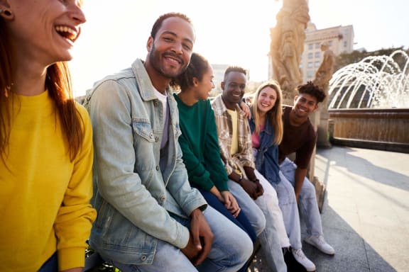 a group of people sitting in front of a fountain