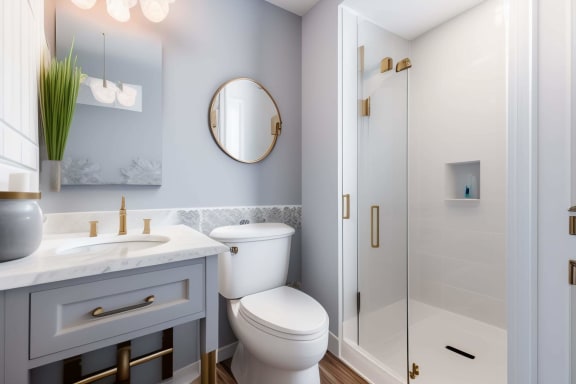 a bathroom with a toilet sink and a shower