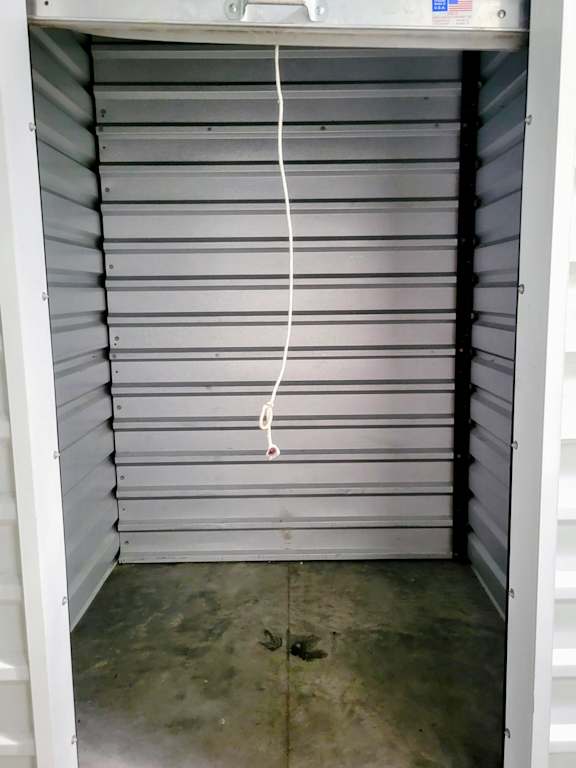 A white closet with a white hanger.