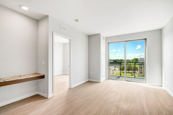 a living room with a large window and a balcony