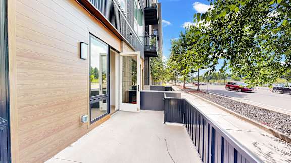 A modern building with a balcony overlooking a street.