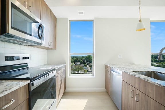 a kitchen with stainless steel appliances and a window