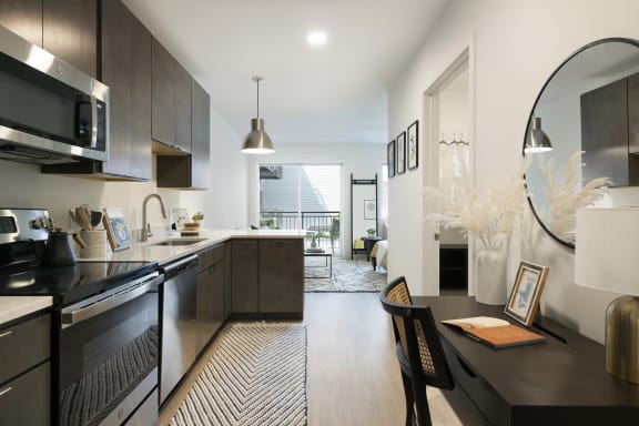 an open kitchen and dining room with a view of a living room