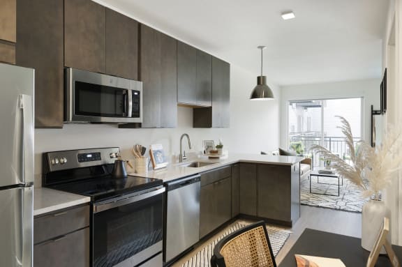 an open kitchen with stainless steel appliances and wooden cabinets