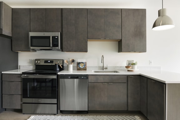 a kitchen with stainless steel appliances and a white counter top