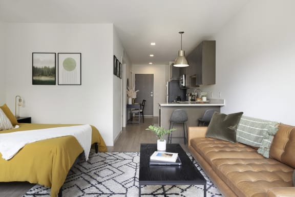 a bedroom and living room with a bed and a couch
