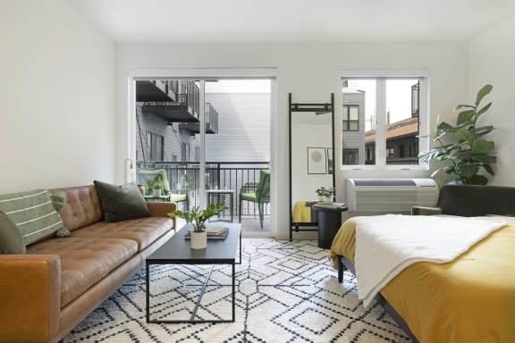 a living room with a couch and a bed
