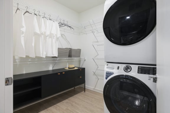 a washer and dryer in a laundry room with a closet