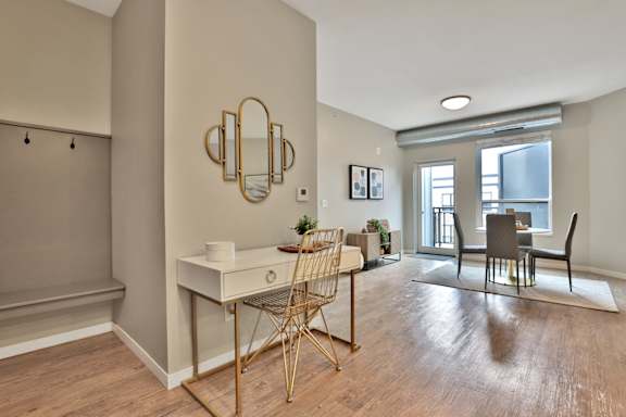 A room with a desk and chairs.