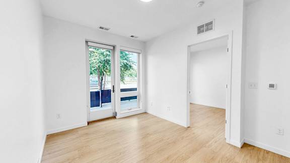 A room with a window and a door.