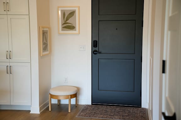 A white door with a black door handle is closed.