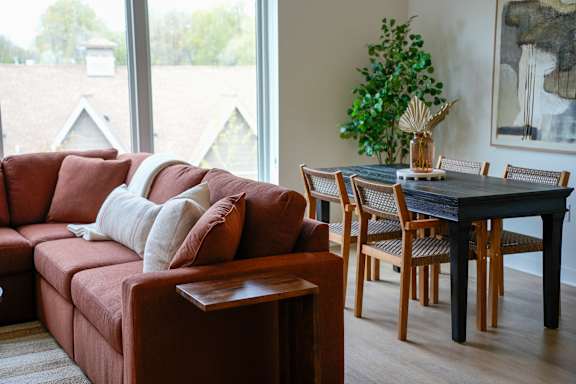 A living room with a red couch and a black table.
