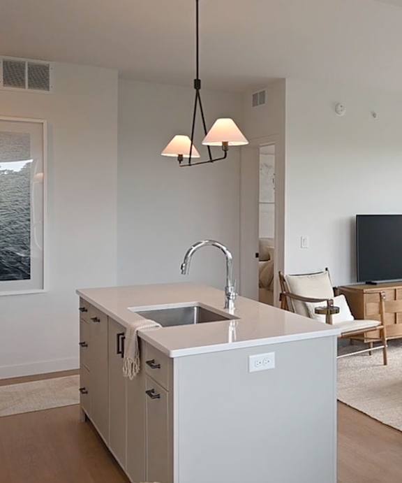 A kitchen with a sink and a counter.