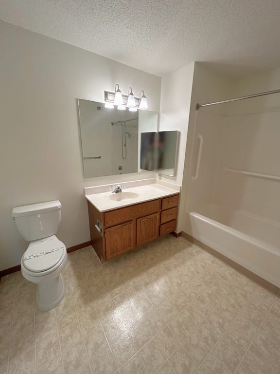 A white toilet sits next to a sink in a bathroom.