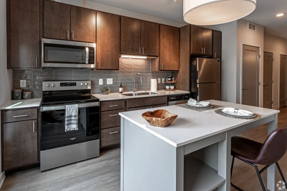 a kitchen with stainless steel appliances and a white counter top