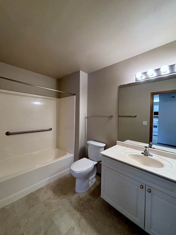 A bathroom with a toilet, sink, and bathtub.