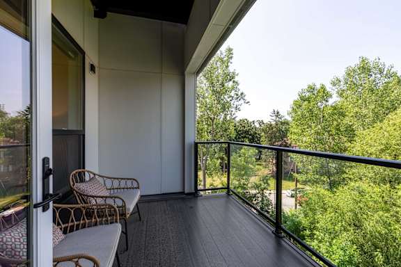 A balcony with a chair and a table.