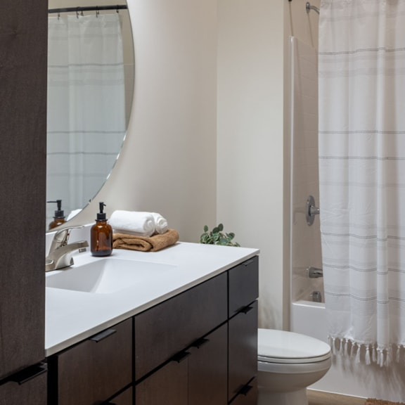 A bathroom with a white sink and a white toilet.