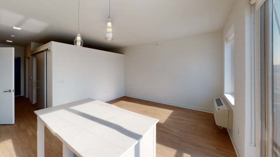 an empty living room with a white table