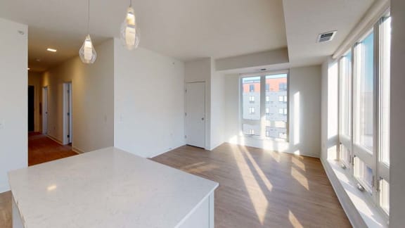 an empty living room with white walls and windows