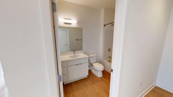 a white bathroom with a toilet and a sink