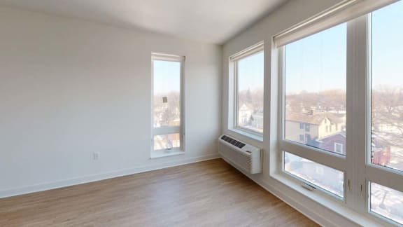 a living room with large windows and a wood floor
