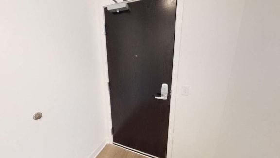 a black door on a white wall in a room