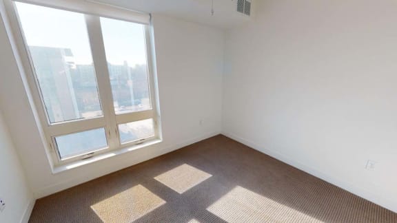 an empty room with a large window and