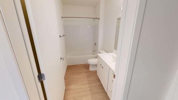 a white bathroom with a toilet and a sink