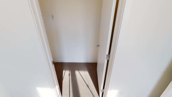 a hallway with a door open to a white room