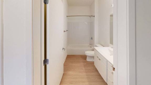 a white bathroom with a toilet and a sink