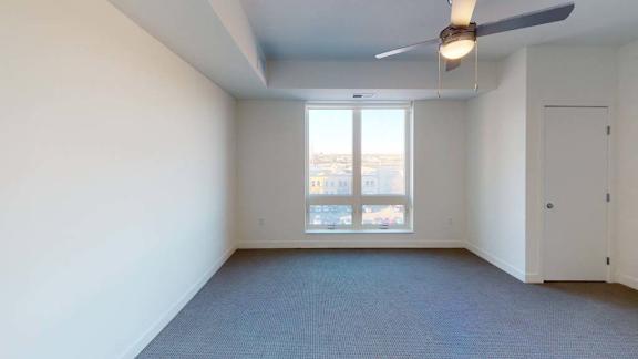an empty room with a ceiling fan