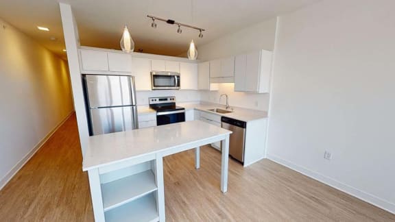 a kitchen with a counter top and a refrigerator