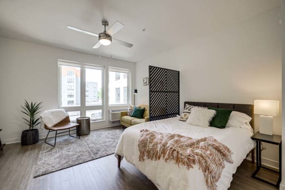 a bedroom with a large bed and a ceiling fan
