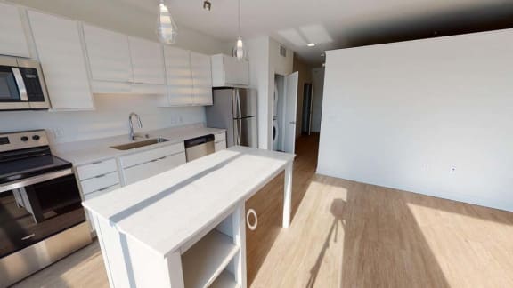 a large white kitchen with a white counter top