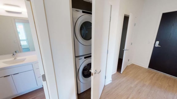 a bathroom with a washer and a dryer in it