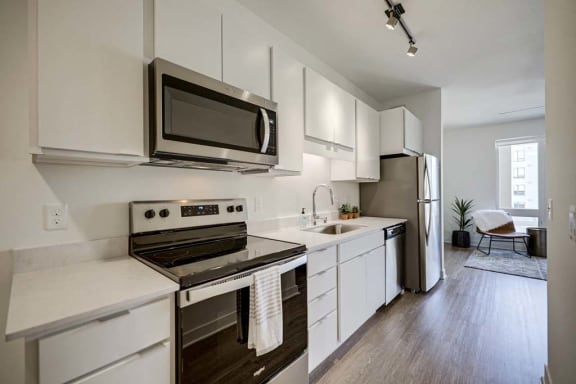 a kitchen with stainless steel appliances and white cabinets