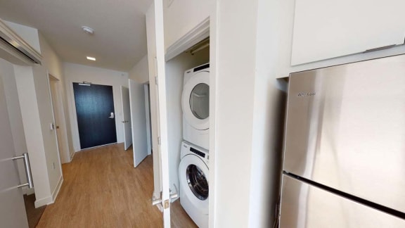 a washer and dryer in a hallway with a door