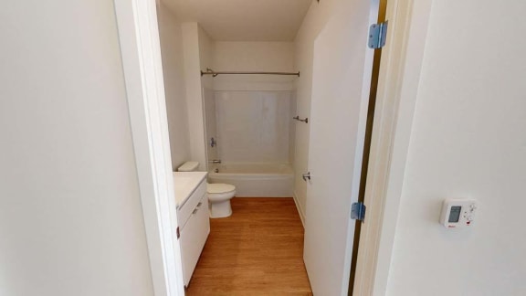 a bathroom with a toilet and a sink and a shower