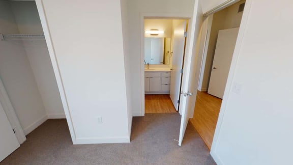 a bedroom with a door open to a bathroom